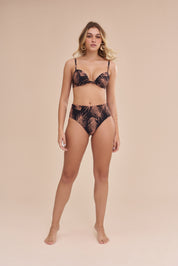 Modelo vestindo conjunto de biquíni com estampa botânica em fundo preto, vista frontal.