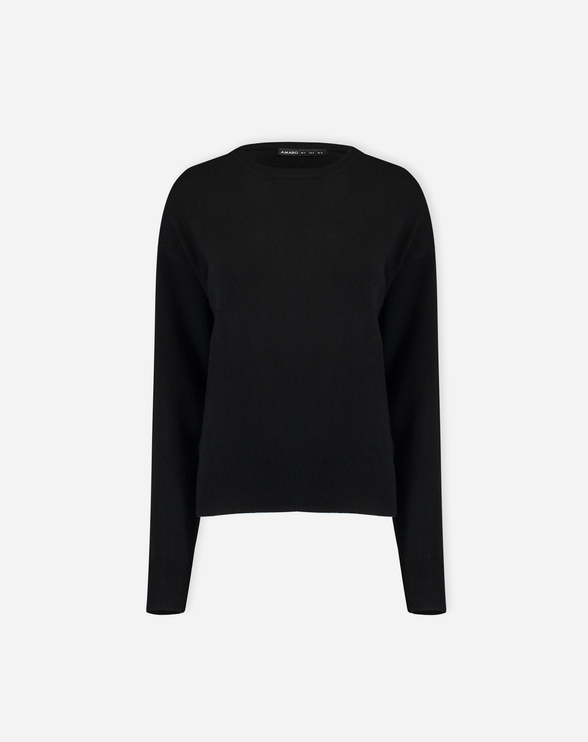 Close da união do suéter com a peça de baixo, evidenciando o caimento e a textura do cashmere preto
